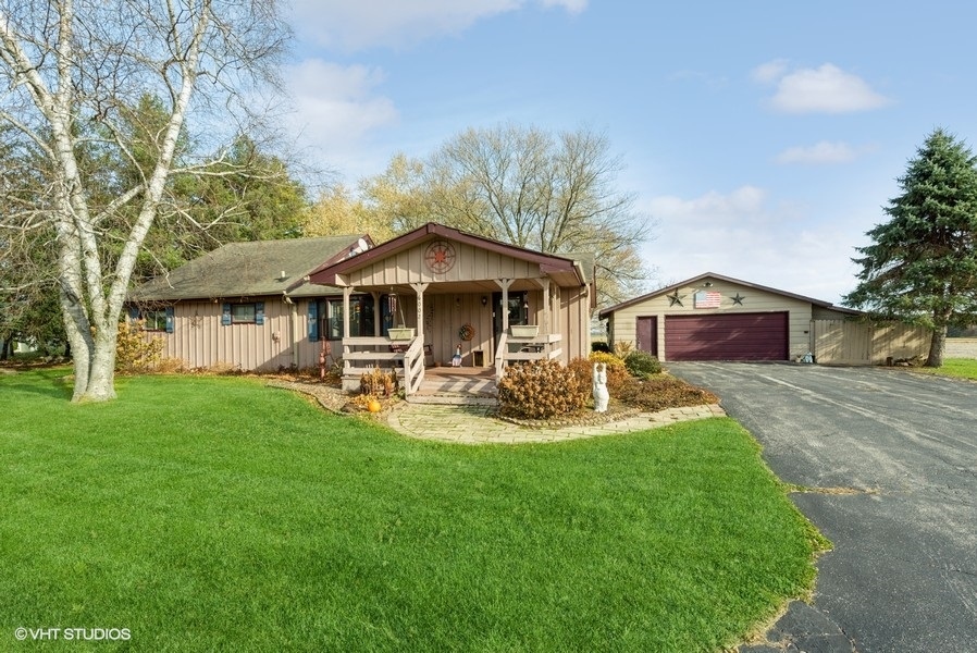 a front view of a house with yard and green space