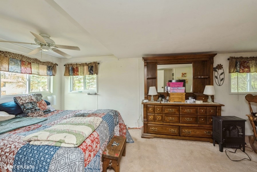 6002 Pine Street Harvard, IL 60033 - Photo 11 of 21 a bedroom with a bed and wooden floor