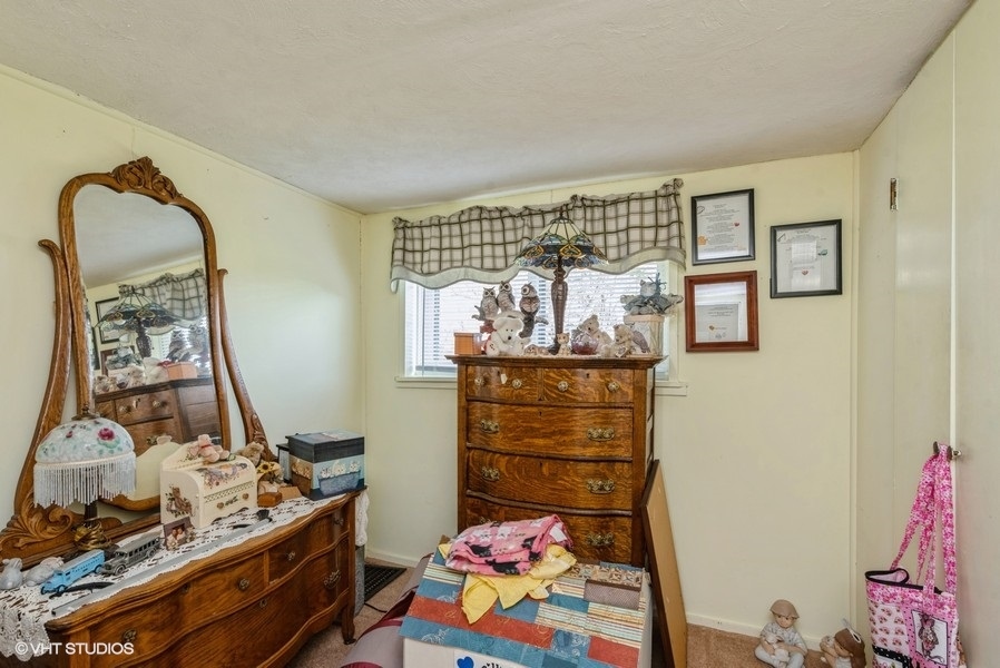 6002 Pine Street Harvard, IL 60033 - Photo 17 of 21 a bed room with a bed and a dresser
