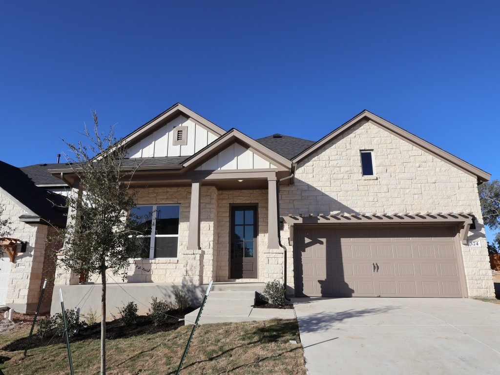 374 Bishop Wood Road Dripping Springs, TX 78620 - Photo 1 of 18 a front view of a house with a yard