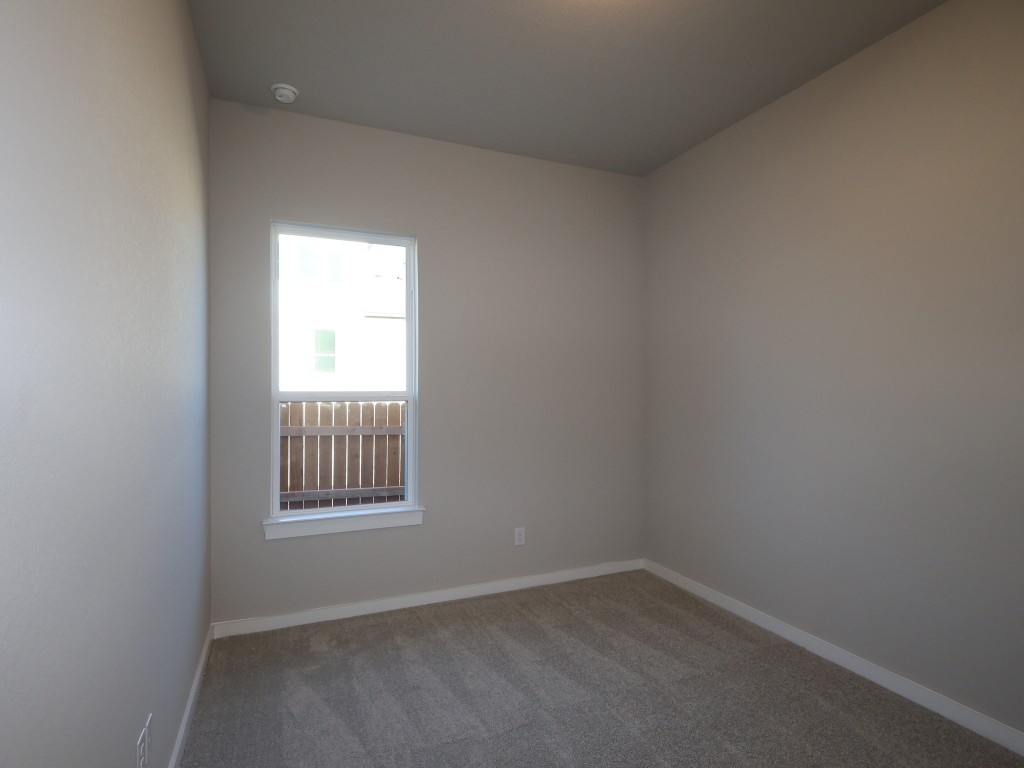 374 Bishop Wood Road Dripping Springs, TX 78620 - Photo 13 of 18 an empty room with a window