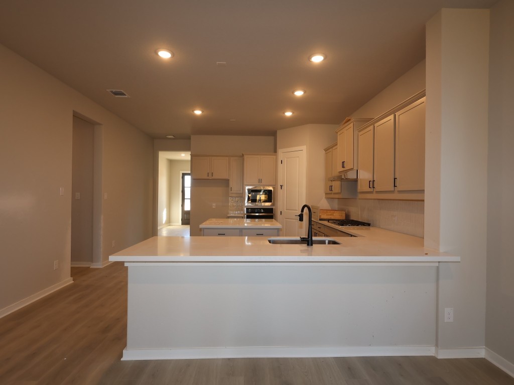 374 Bishop Wood Road Dripping Springs, TX 78620 - Photo 2 of 18 a view of kitchen with stainless steel appliances granite countertop a sink a stove and a refrigerator