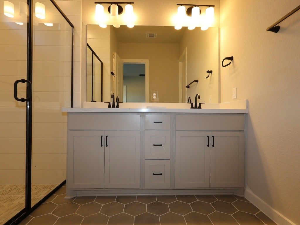 374 Bishop Wood Road Dripping Springs, TX 78620 - Photo 8 of 18 a bathroom with a sink and a mirror