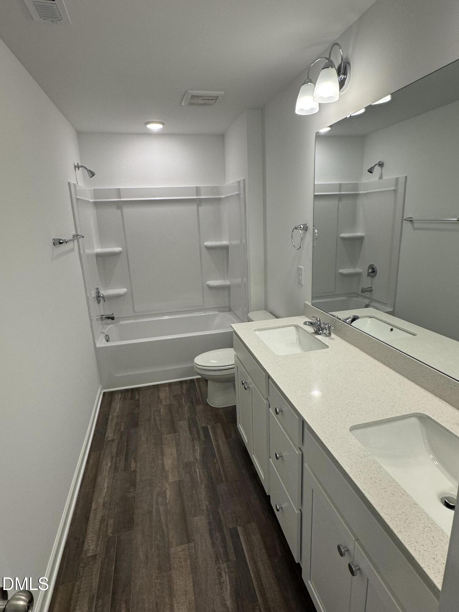 136 Vulcan Street Garner, NC 27529 - Photo 14 of 27 a bathroom with a sink a toilet a mirror and shower