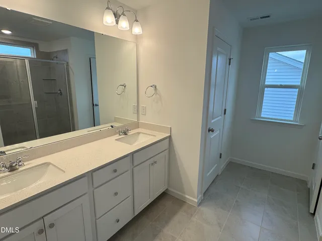 a bathroom with a glass shower door