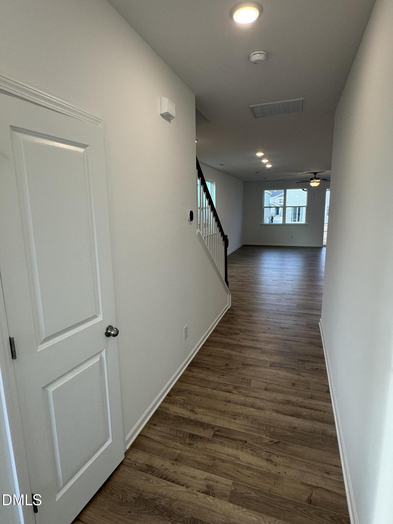 136 Vulcan Street Garner, NC 27529 - Photo 5 of 27 a view of a hallway view with wooden floor and staircase