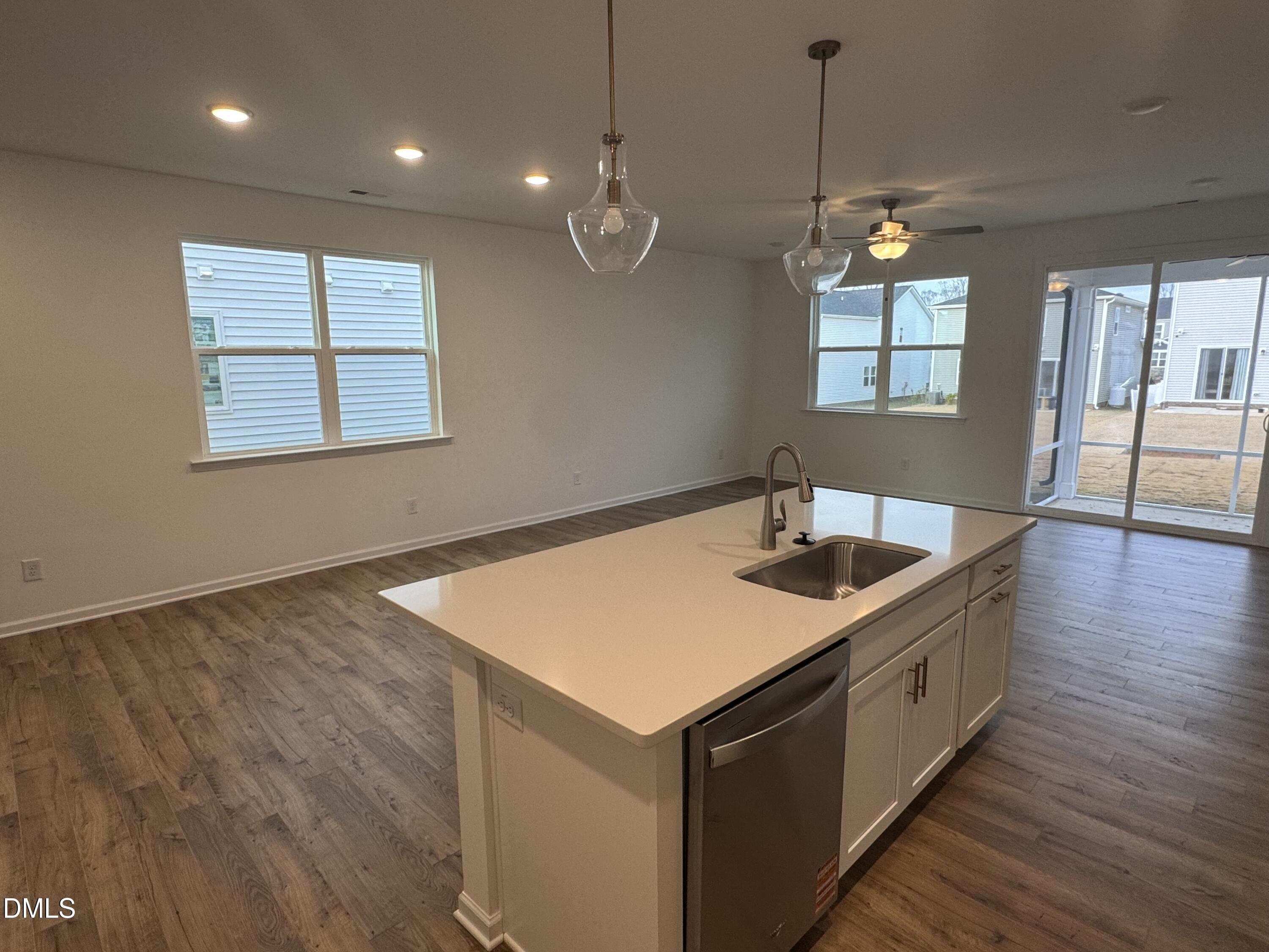 136 Vulcan Street Garner, NC 27529 - Photo 9 of 27 a kitchen that has a sink a window and wooden floor