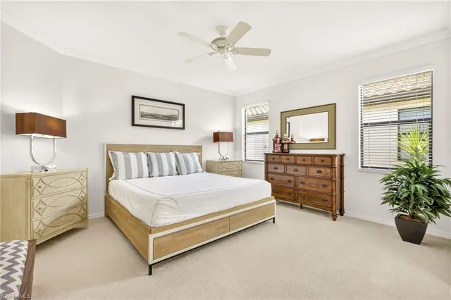 a spacious bedroom with a bed and a chandelier