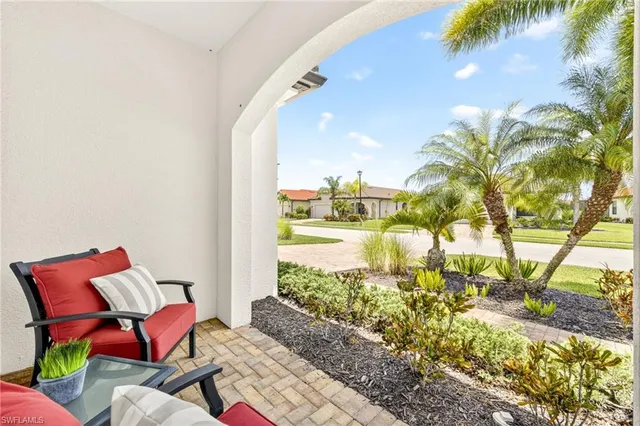 a workspace with furniture and a floor to ceiling window