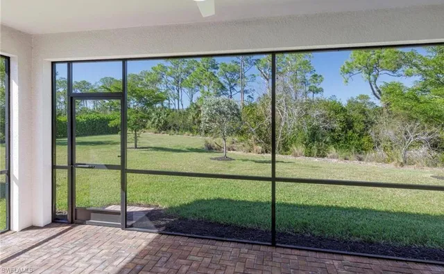 a view of a porch with a floor to ceiling window and a yard