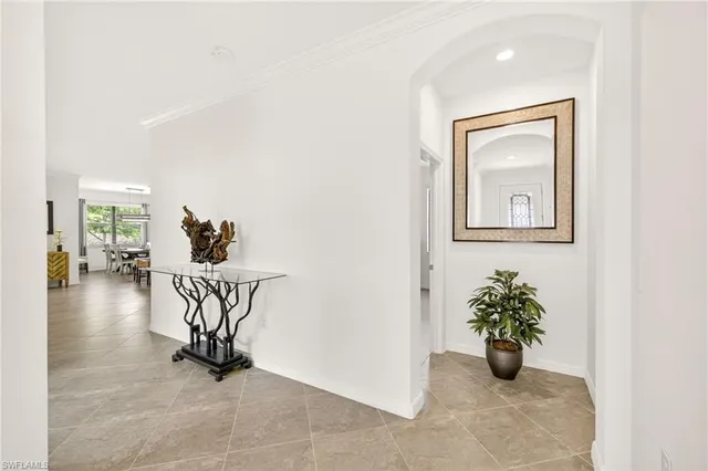 a view of a hallway with wooden floor and a potted plant