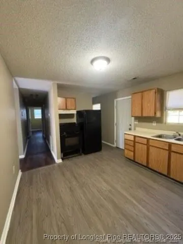 a large kitchen with stainless steel appliances granite countertop a large counter top and a stove