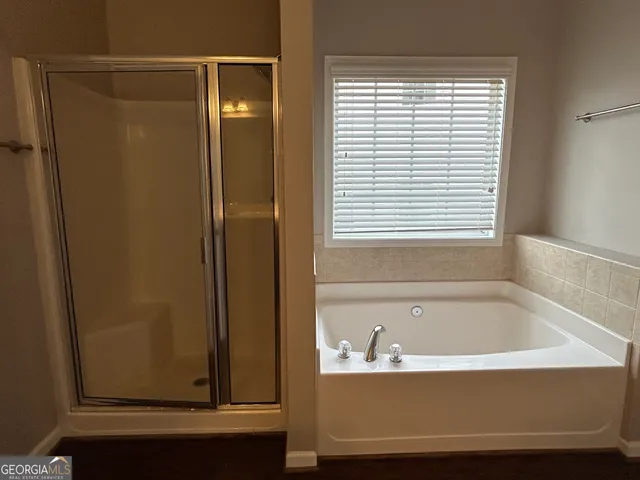 a bathroom with a bathtub and a window