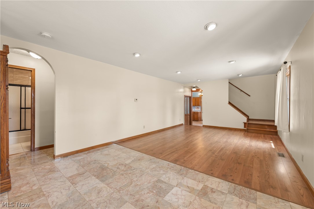 9990 Broadview Road Broadview Heights, OH 44147 - Photo 12 of 47 Unfurnished living room with arched walkways, recessed lighting, and stairs