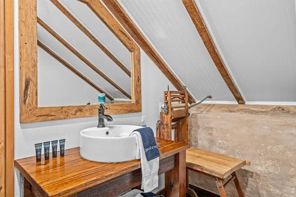 a bed sitting in a bedroom next to a window