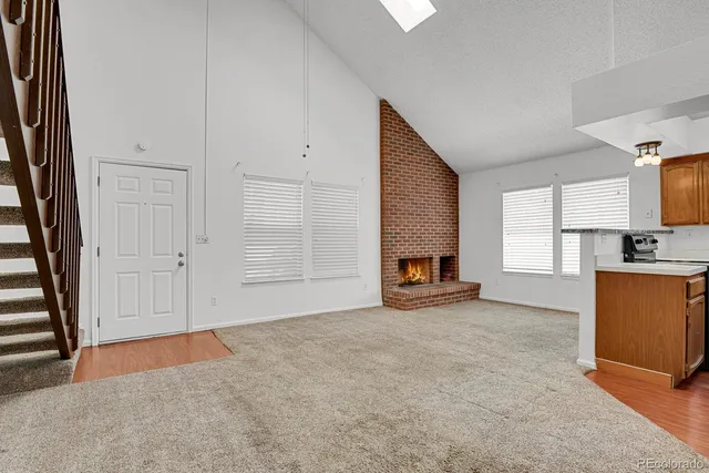 an empty room with furniture and a fireplace