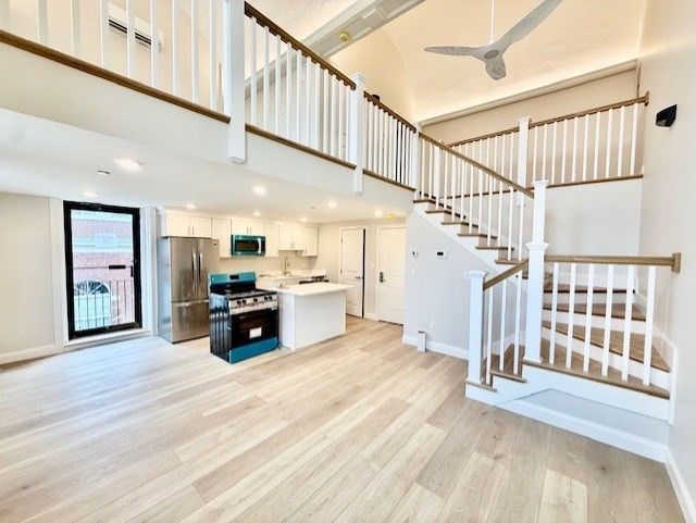 220 Winthrop Street, Unit 206 Winthrop, MA 02152 - Photo 1 of 15 a living room with stairs and a wooden floor