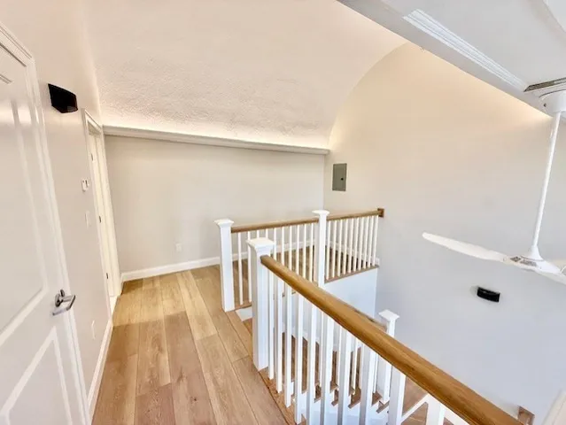a view of a hallway with wooden floor and entryway