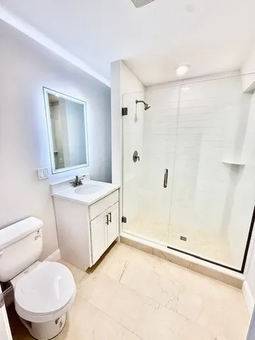 a bathroom with a toilet sink and a mirror