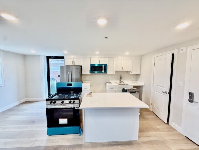 220 Winthrop Street, Unit 206 Winthrop, MA 02152 - Photo 4 of 15 a kitchen with stainless steel appliances a refrigerator stove and sink