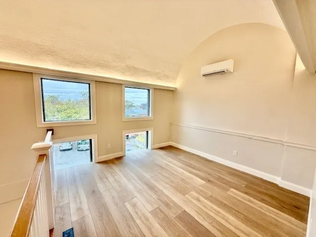 a view of an empty room and wooden floor