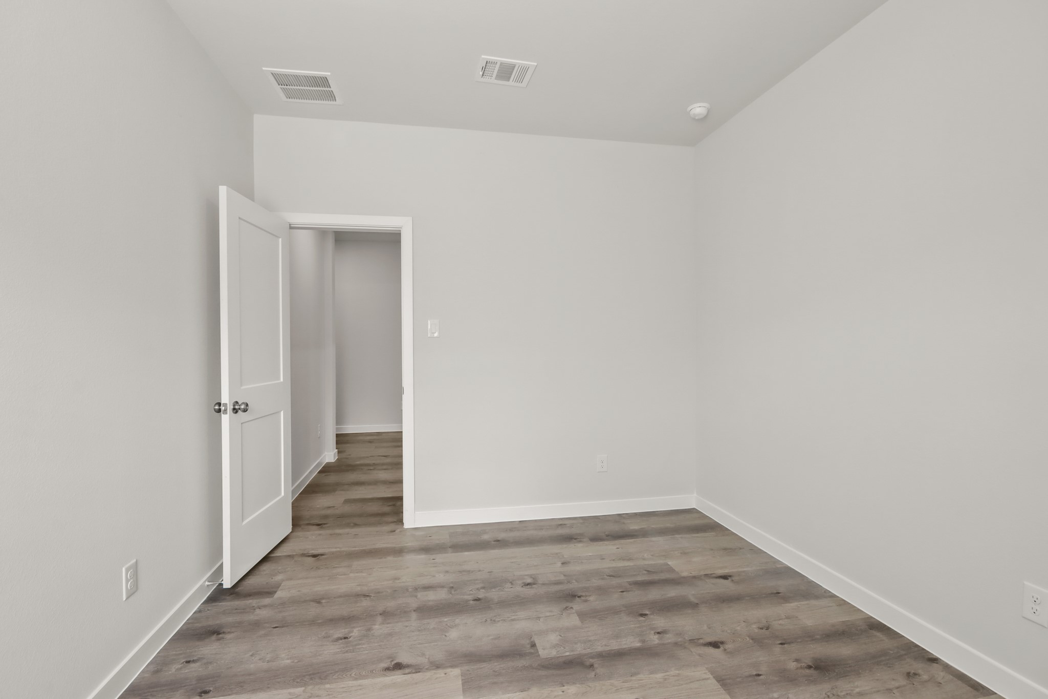 9790 Caney Bend Road Conroe, TX 77303 - Photo 14 of 22 a view of an empty room with wooden floor