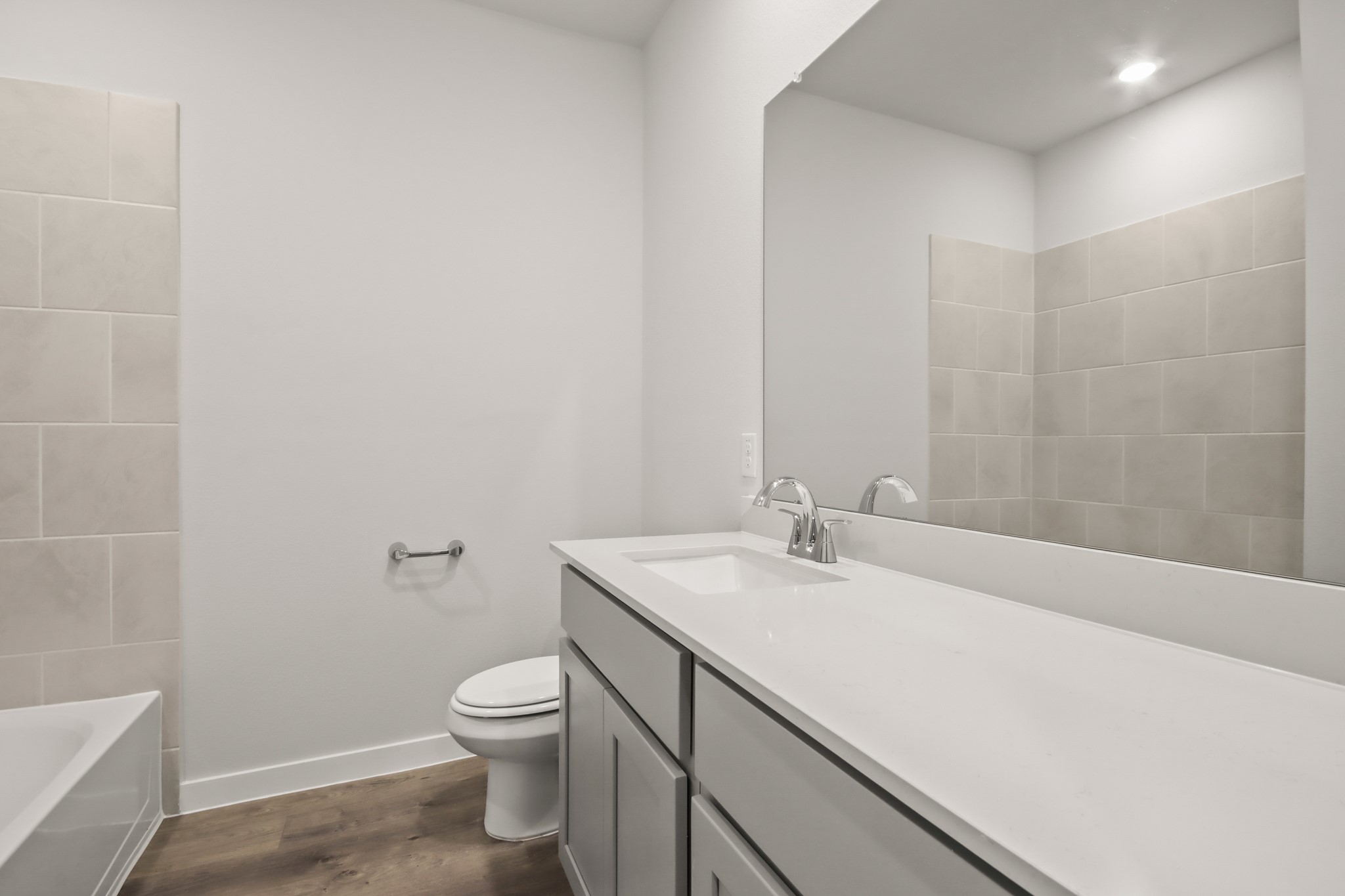 9790 Caney Bend Road Conroe, TX 77303 - Photo 17 of 22 a bathroom with a granite countertop toilet a sink and a mirror