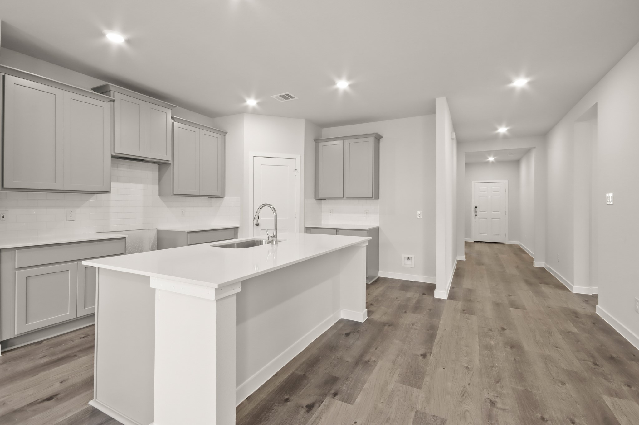 9790 Caney Bend Road Conroe, TX 77303 - Photo 4 of 22 a kitchen with a sink stainless steel appliances and white cabinets
