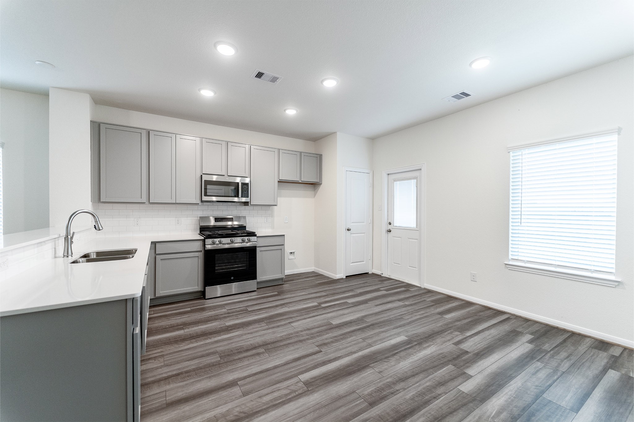 3527 Prairie Rose Trail Angleton, TX 77515 - Photo 10 of 19 a kitchen with granite countertop a stove and a sink