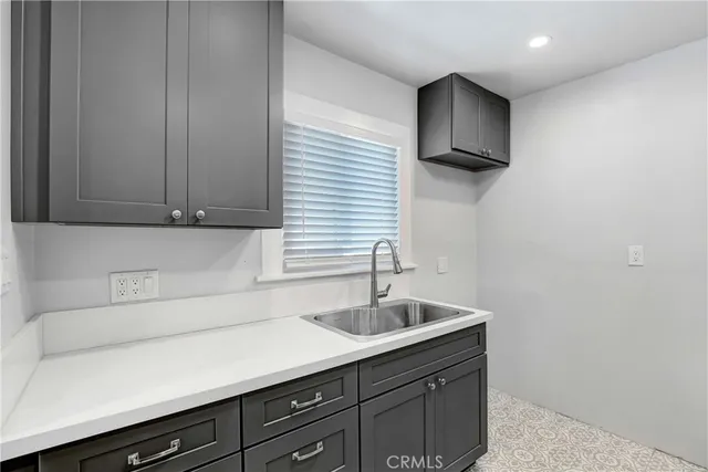 a kitchen with a sink and cabinets