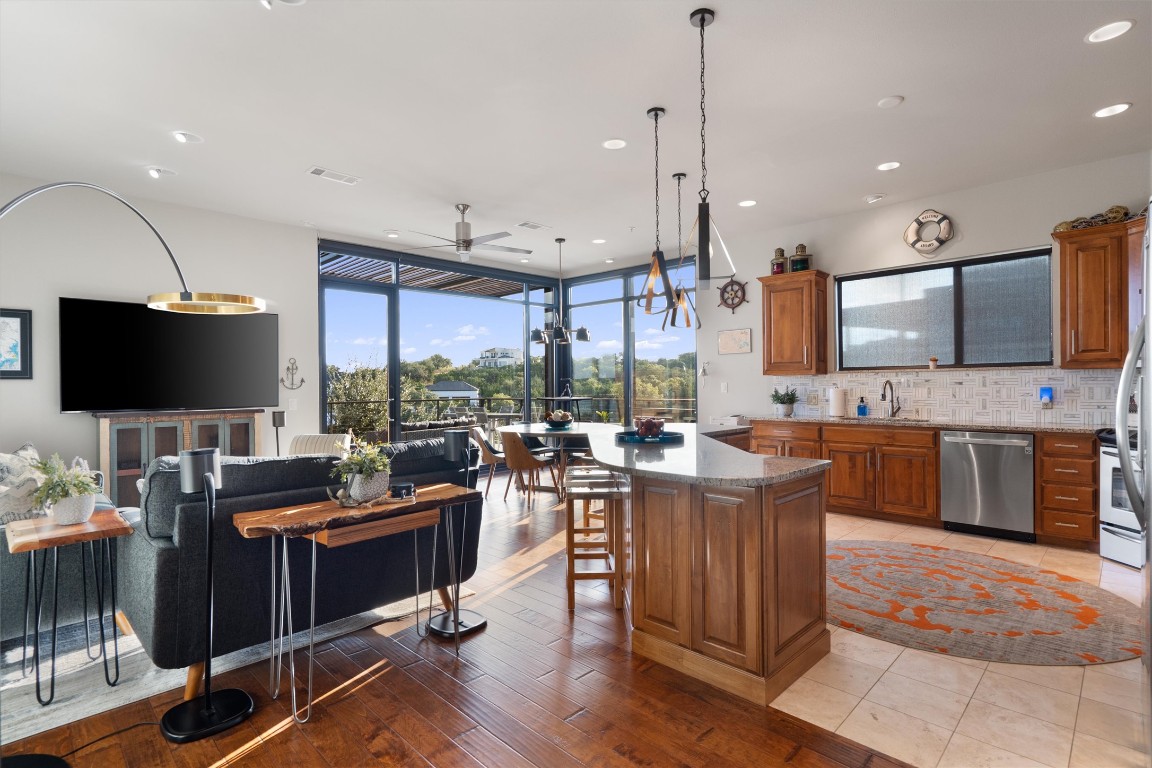 1101 Ivean Pearson Road, Unit E208 Lago Vista, TX 78645 - Photo 13 of 40 a living room with furniture a flat screen tv and kitchen view