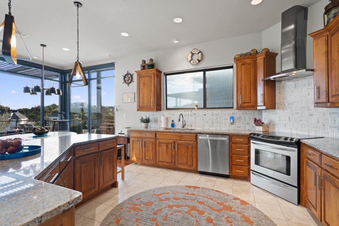 1101 Ivean Pearson Road, Unit E208 Lago Vista, TX 78645 - Photo 14 of 40 a large kitchen with kitchen island a large counter space a sink stainless steel appliances and cabinets