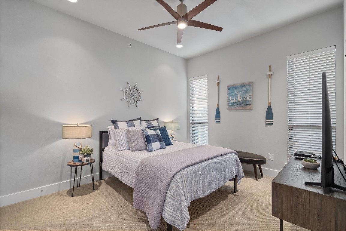 1101 Ivean Pearson Road, Unit E208 Lago Vista, TX 78645 - Photo 22 of 40 a bedroom with a bed and a flat screen tv