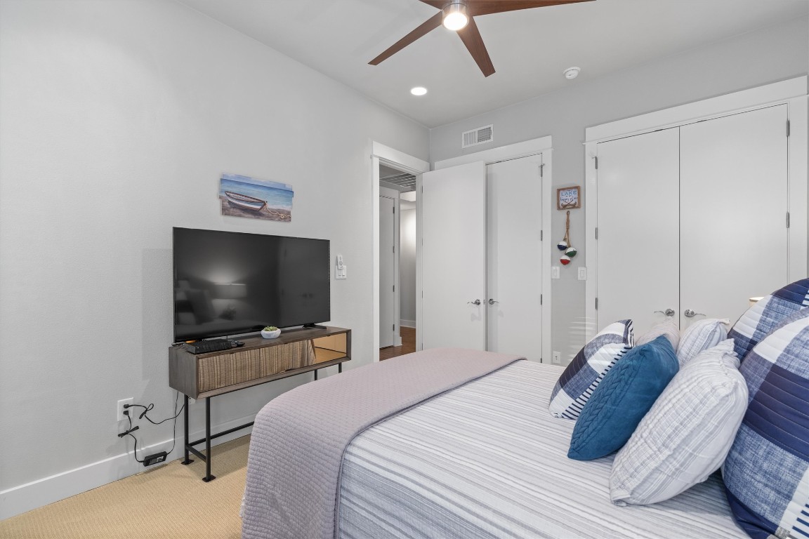 1101 Ivean Pearson Road, Unit E208 Lago Vista, TX 78645 - Photo 23 of 40 a bedroom with a bed and a flat screen tv