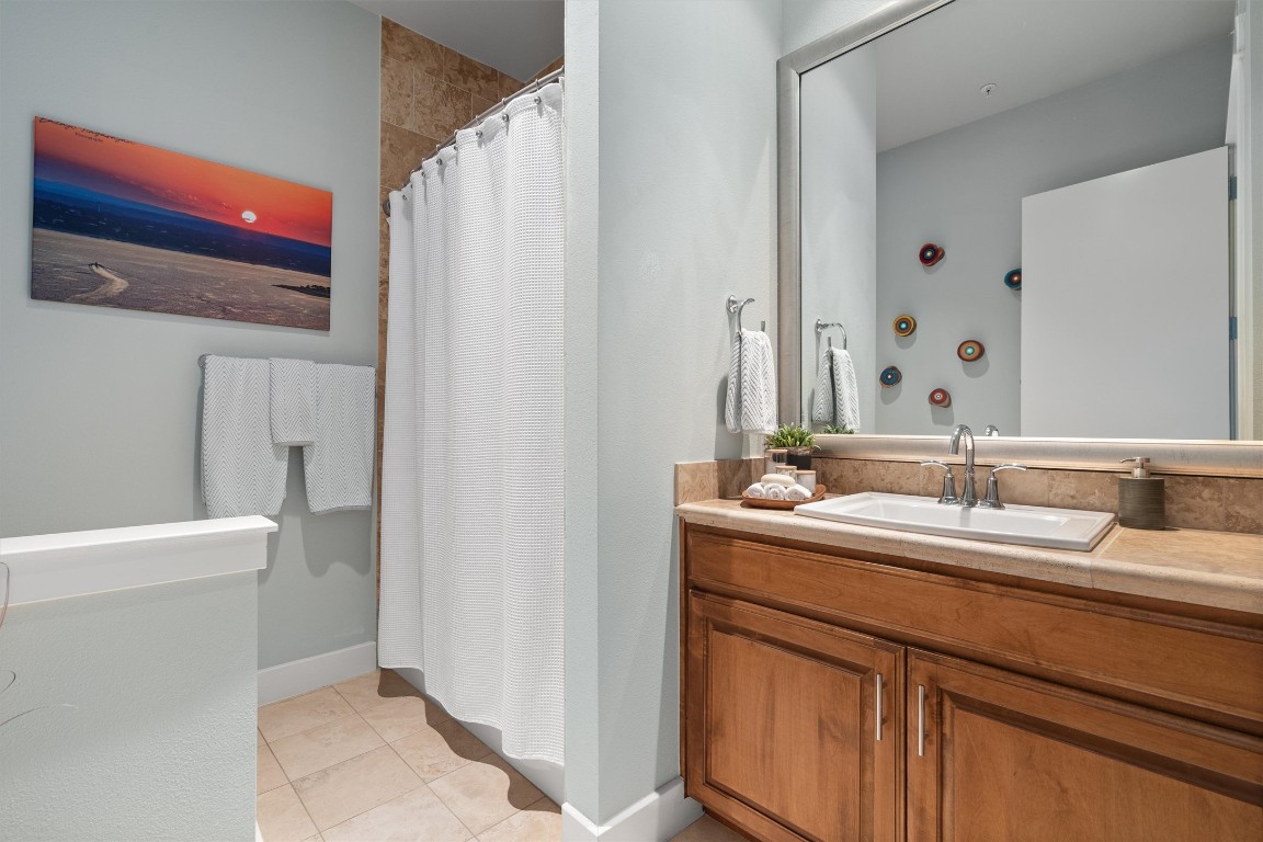 1101 Ivean Pearson Road, Unit E208 Lago Vista, TX 78645 - Photo 24 of 40 a bathroom with a double vanity sink and mirror