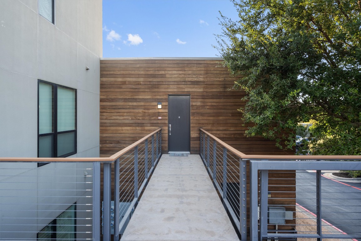 1101 Ivean Pearson Road, Unit E208 Lago Vista, TX 78645 - Photo 3 of 40 a view of balcony with wooden floor and fence