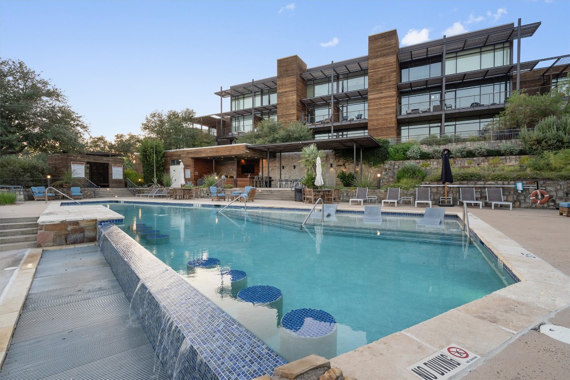 1101 Ivean Pearson Road, Unit E208 Lago Vista, TX 78645 - Photo 36 of 40 a swimming pool with outdoor seating and yard