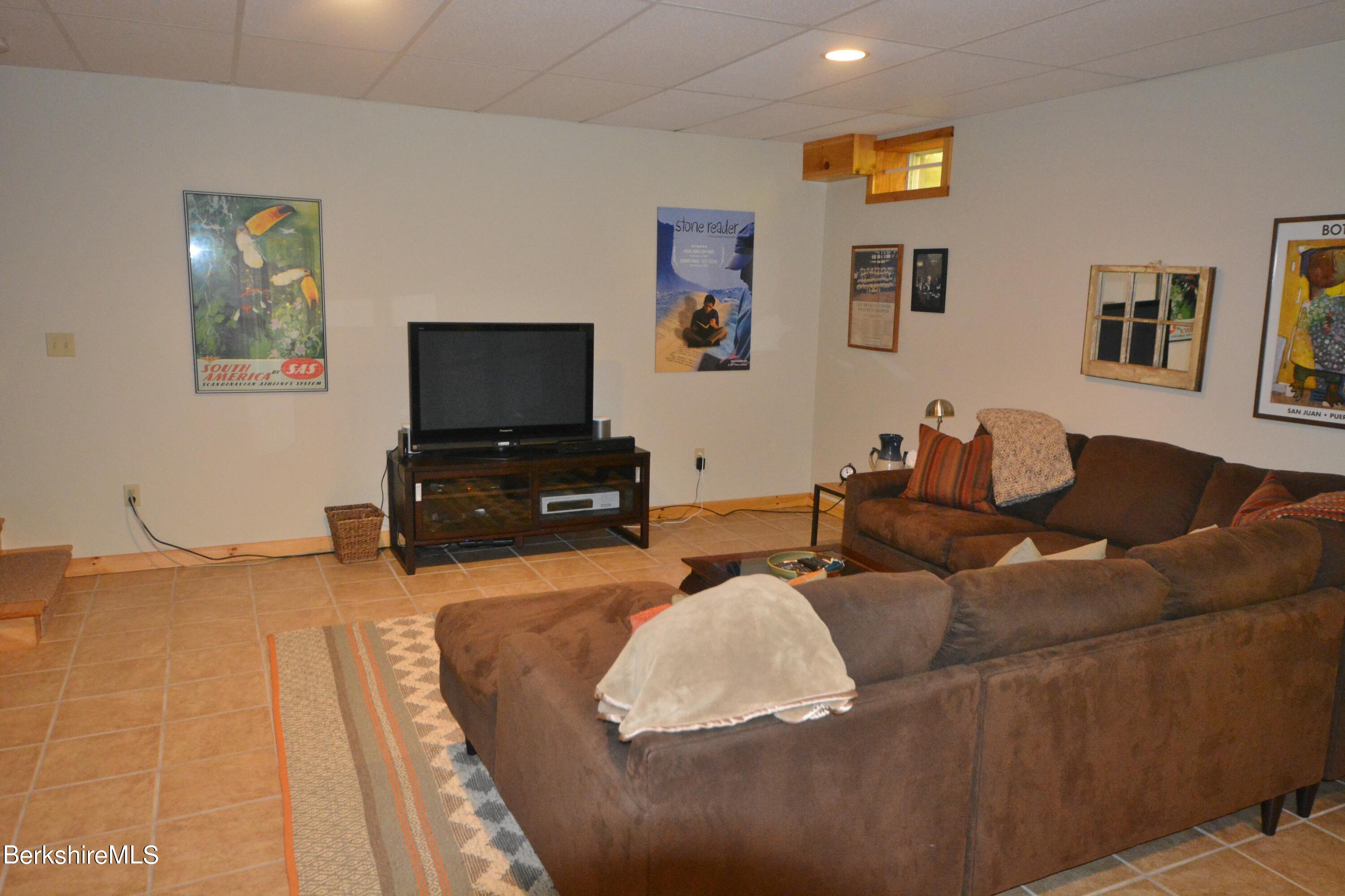 462 Bonny Rigg Hill Road Becket, MA 01223 - Photo 18 of 28 a living room with furniture and a flat screen tv