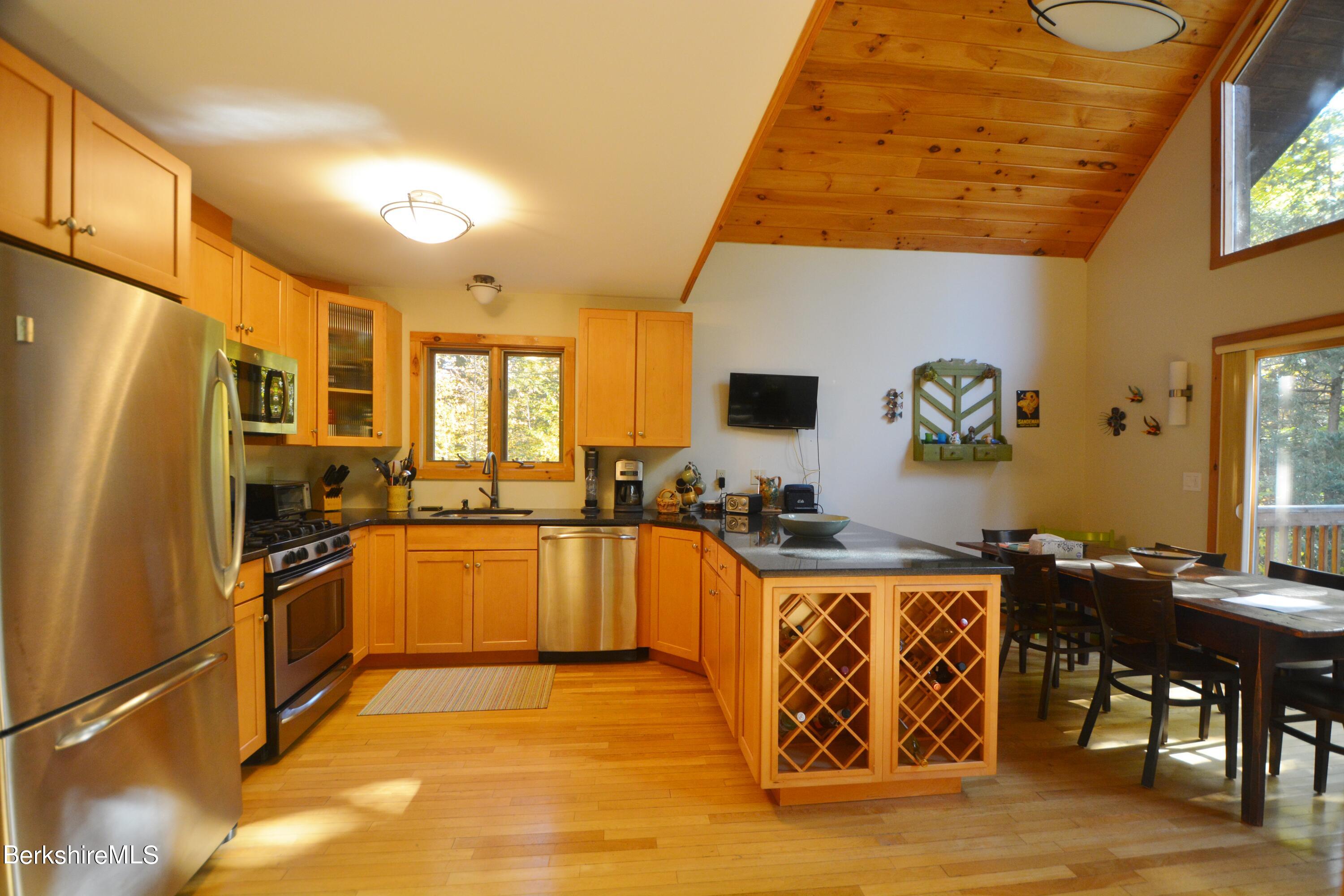 462 Bonny Rigg Hill Road Becket, MA 01223 - Photo 8 of 28 a kitchen with stainless steel appliances granite countertop a stove a refrigerator a sink dishwasher and a microwave