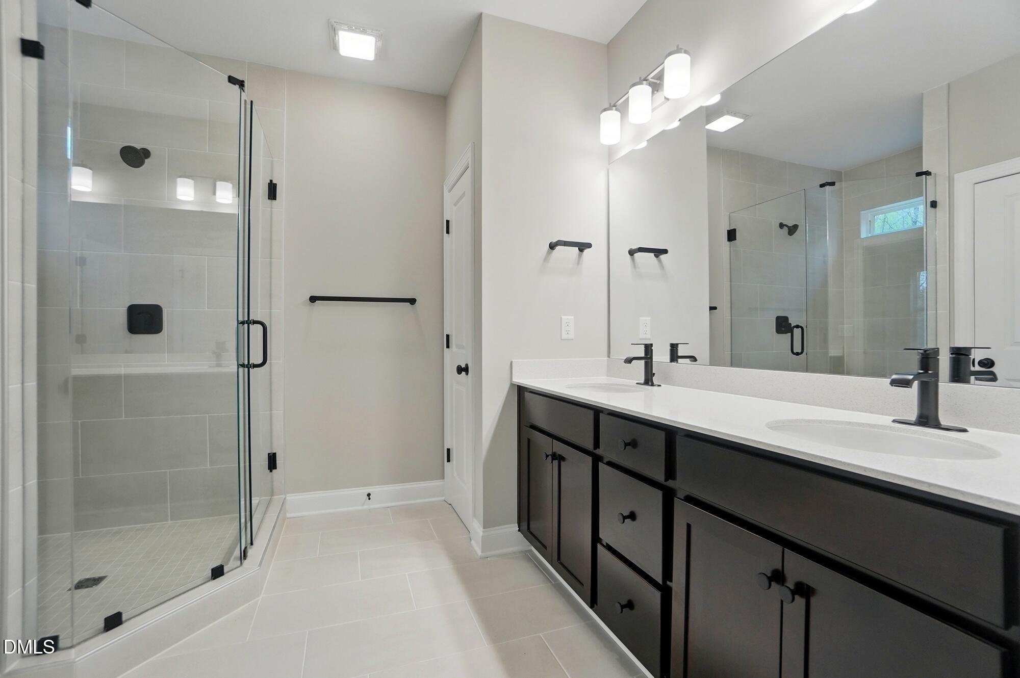 285 Gilliland Road Siler City, NC 27344 - Photo 18 of 45 a spacious bathroom with a double vanity sink mirror and shower