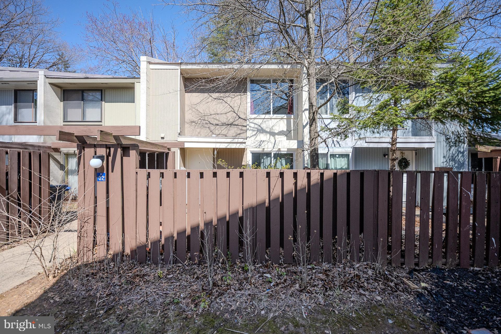 2202 Southgate Square Reston, VA 20191 - Photo 1 of 26 a view of a house with a wooden fence