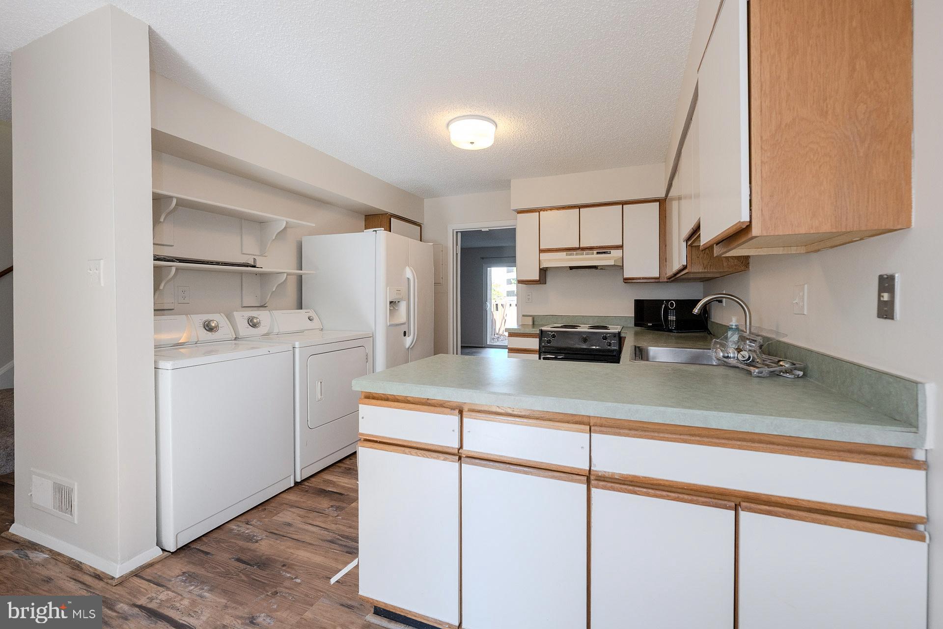 2202 Southgate Square Reston, VA 20191 - Photo 11 of 26 a kitchen with a sink cabinets and window