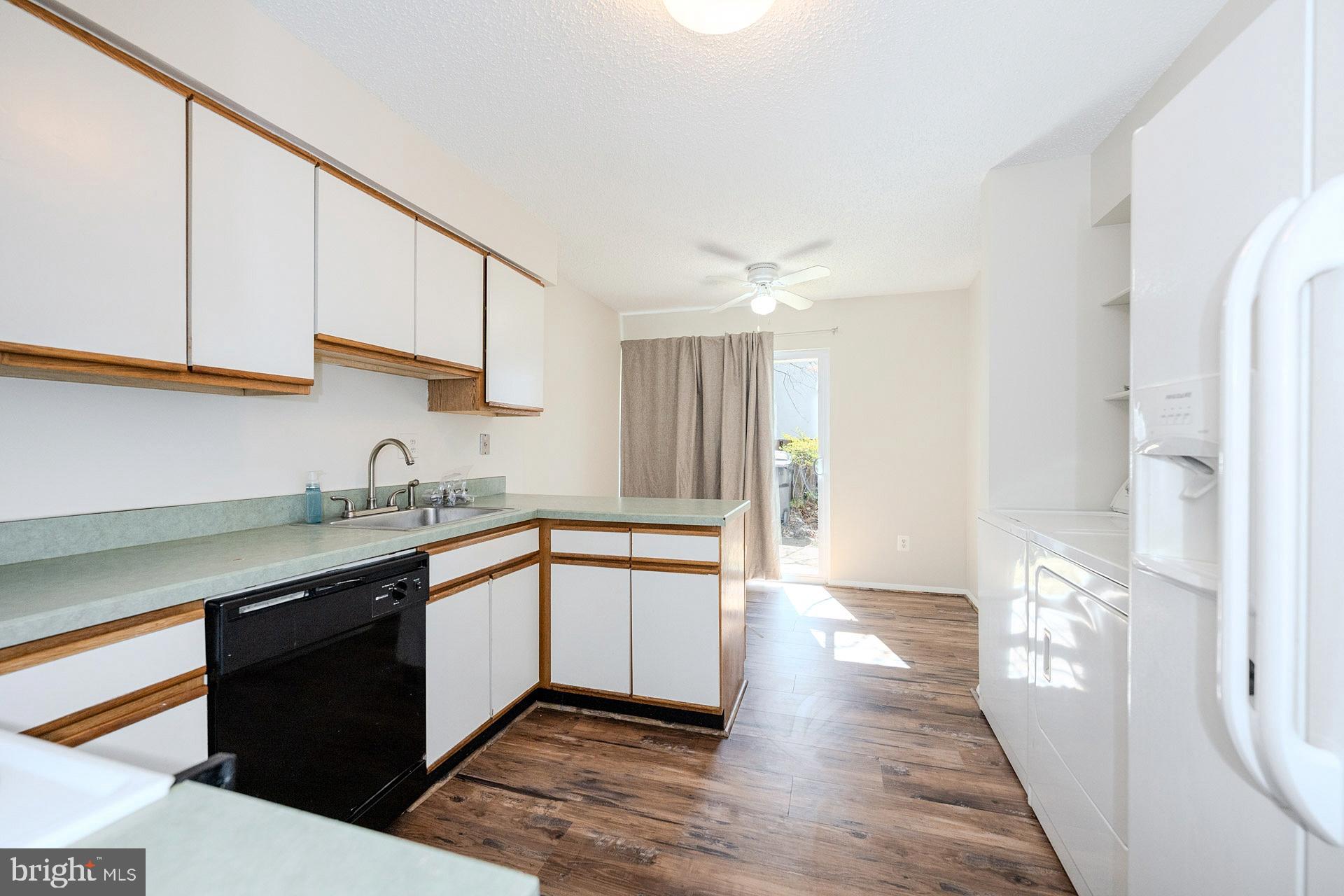 2202 Southgate Square Reston, VA 20191 - Photo 12 of 26 a kitchen with stainless steel appliances granite countertop a sink and cabinets