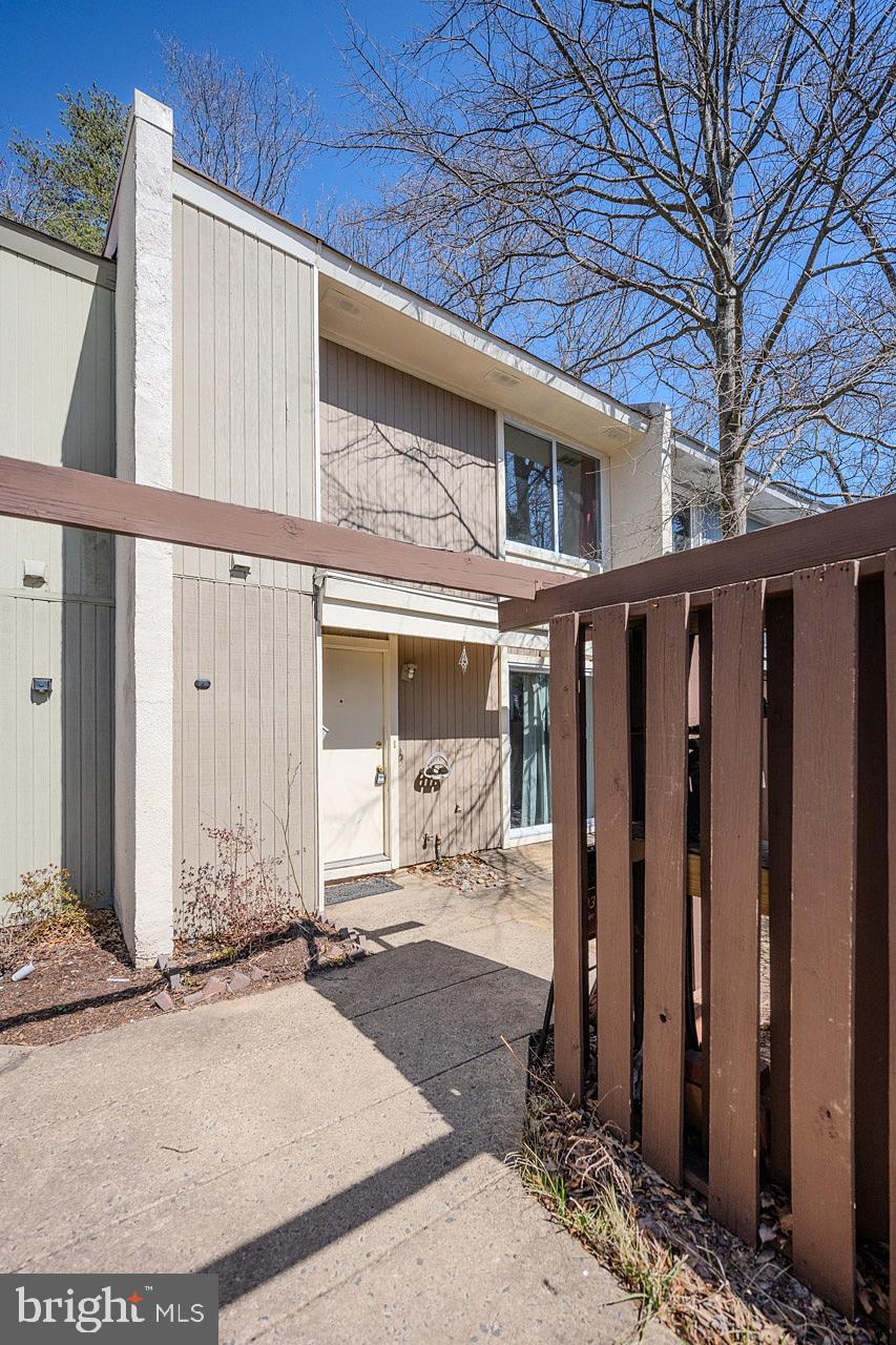 2202 Southgate Square Reston, VA 20191 - Photo 2 of 26 a front view of a house with a garden