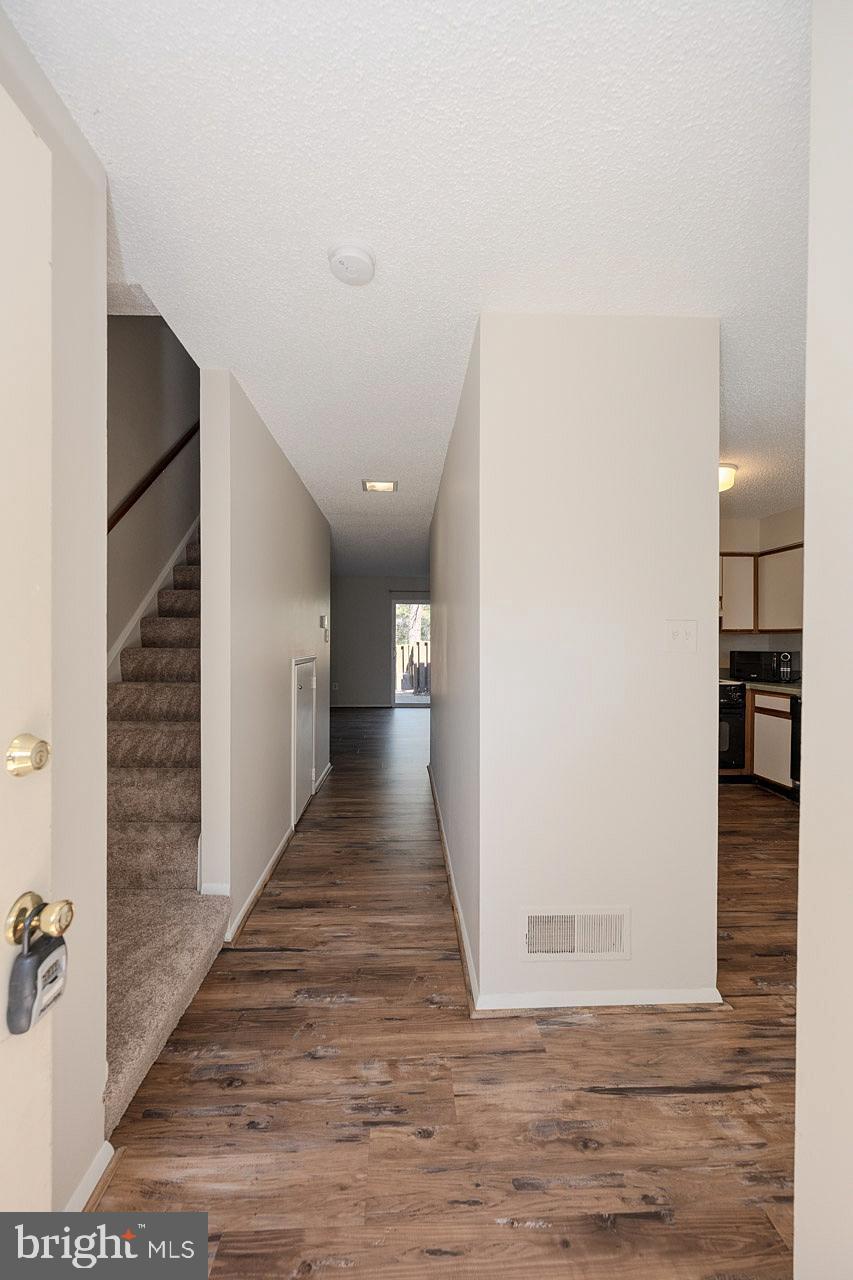 2202 Southgate Square Reston, VA 20191 - Photo 7 of 26 a view of a hallway with wooden floor and staircase