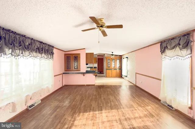 a spacious bedroom with a large bed and a chandelier
