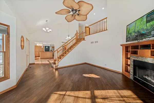 a large kitchen with stainless steel appliances granite countertop a stove and a refrigerator