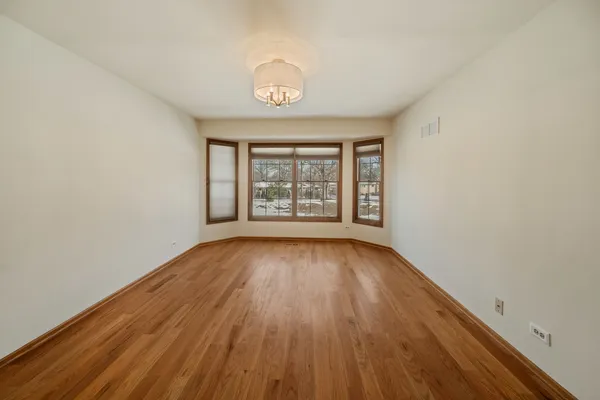 a view of a bedroom with wooden floor