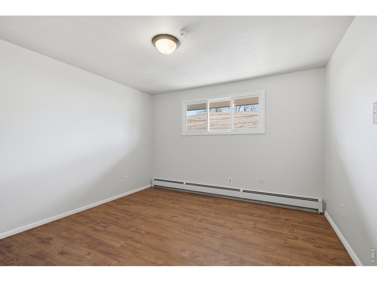 11590 West 39th Place Wheat Ridge, CO 80033 - Photo 15 of 37 an empty room with wooden floor and windows