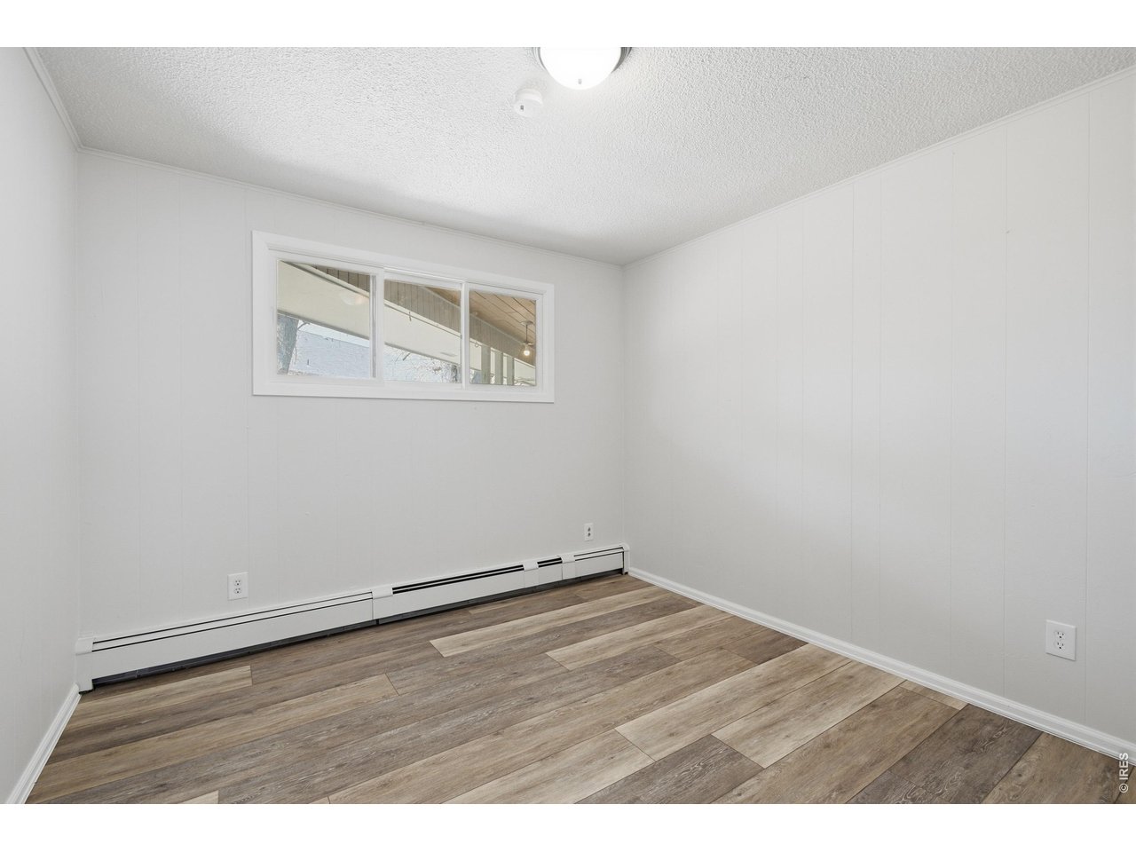 11590 West 39th Place Wheat Ridge, CO 80033 - Photo 16 of 37 an empty room with wooden floor and windows